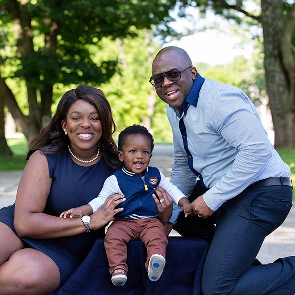 Our pediatric dentist in East Norriton, PA, Dr. Ngozi Okoh sitting with her husband and her baby in a park